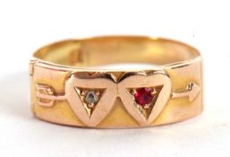 A ruby and diamond double heart ring, the upper half with two hearts and an arrow, one set with a