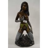 A 20th Century bronzed metal model of a knealing young lady in stockings and suspenders, sat on a