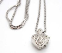 A diamond heart locket and chain, the hinged locket set with small round diamonds to front and plain