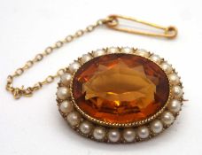 A late 19th century citrine and split pearl brooch, the oval citrine in collet mount and open