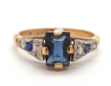 A 9ct Art Deco style ring, the central blue paste stone in a four claw mount, with diamond and