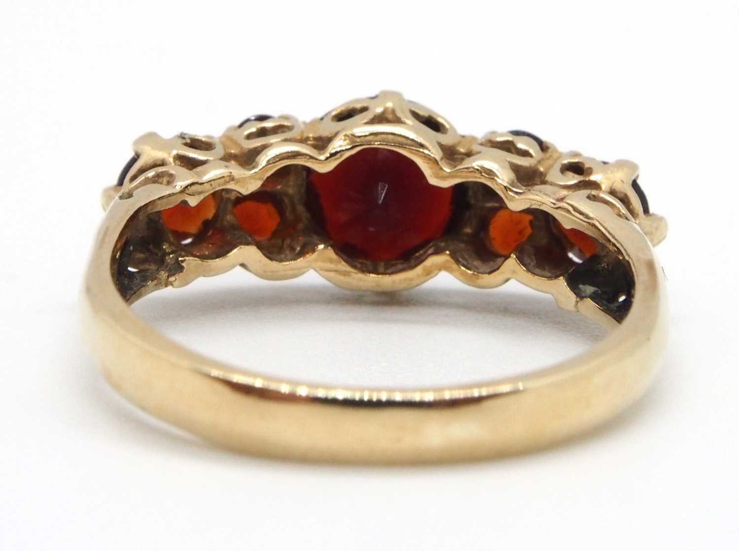 A 9ct garnet ring, the three principal graduated round garnets interspaced with small round garnets, - Image 5 of 7