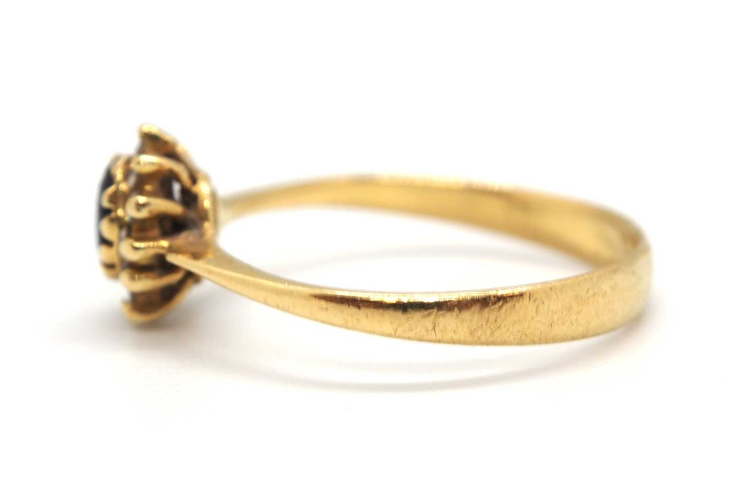 A sapphire and diamond cluster ring, the central oval sapphire surrounded by small round diamonds, - Image 5 of 7