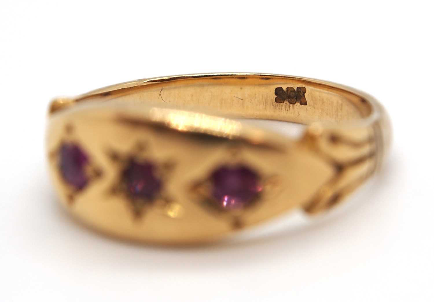 An 9ct ruby ring, the three round gypsy set rubies with plain band stamped 9ct, size I-J, 2.9g - Image 6 of 7