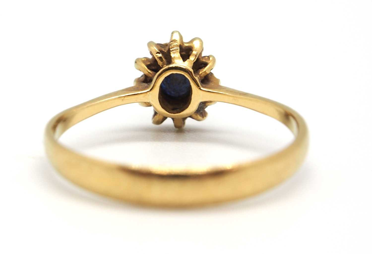 A sapphire and diamond cluster ring, the central oval sapphire surrounded by small round diamonds, - Image 6 of 7