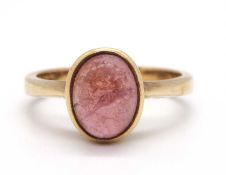 A 9ct pink tourmaline ring, the oval pink tourmaline cabochon, collet mounted to a plain band with