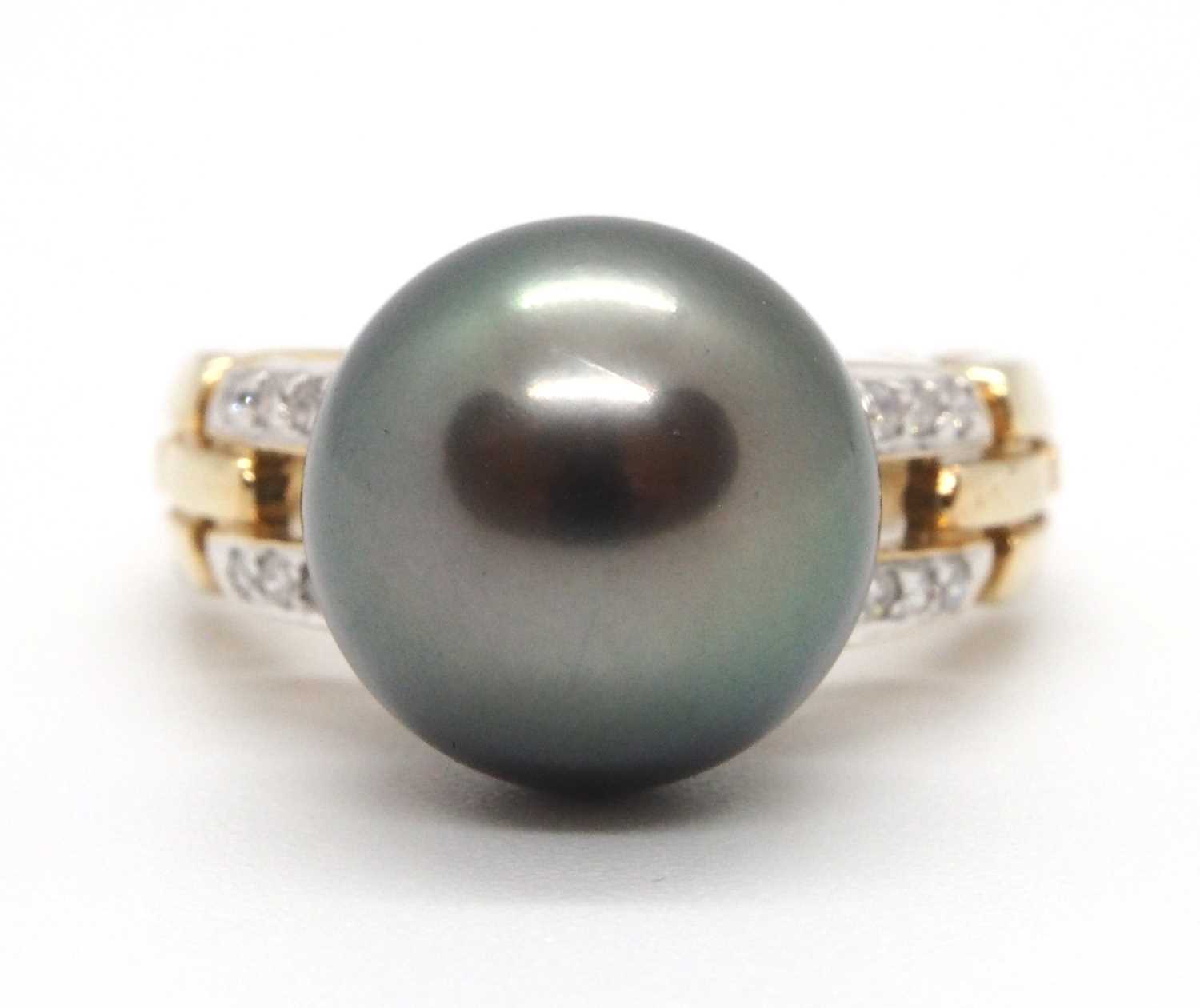 A 9ct cultured pearl and diamond ring, the round grey cultured pearl, approx. 12mm diameter, in a