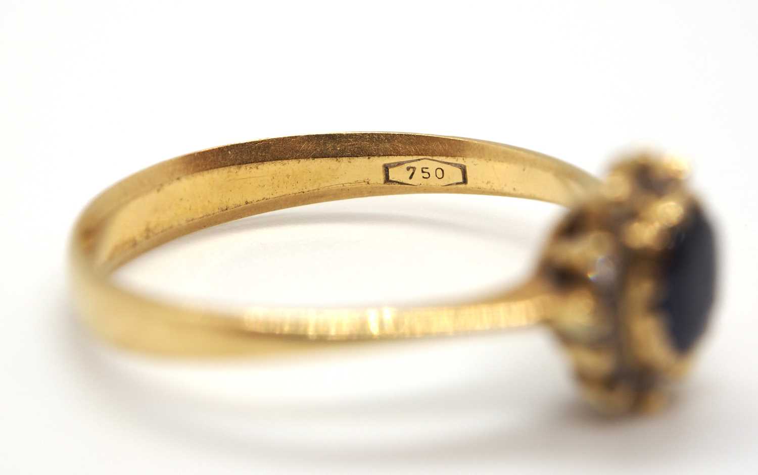 A sapphire and diamond cluster ring, the central oval sapphire surrounded by small round diamonds, - Image 7 of 7