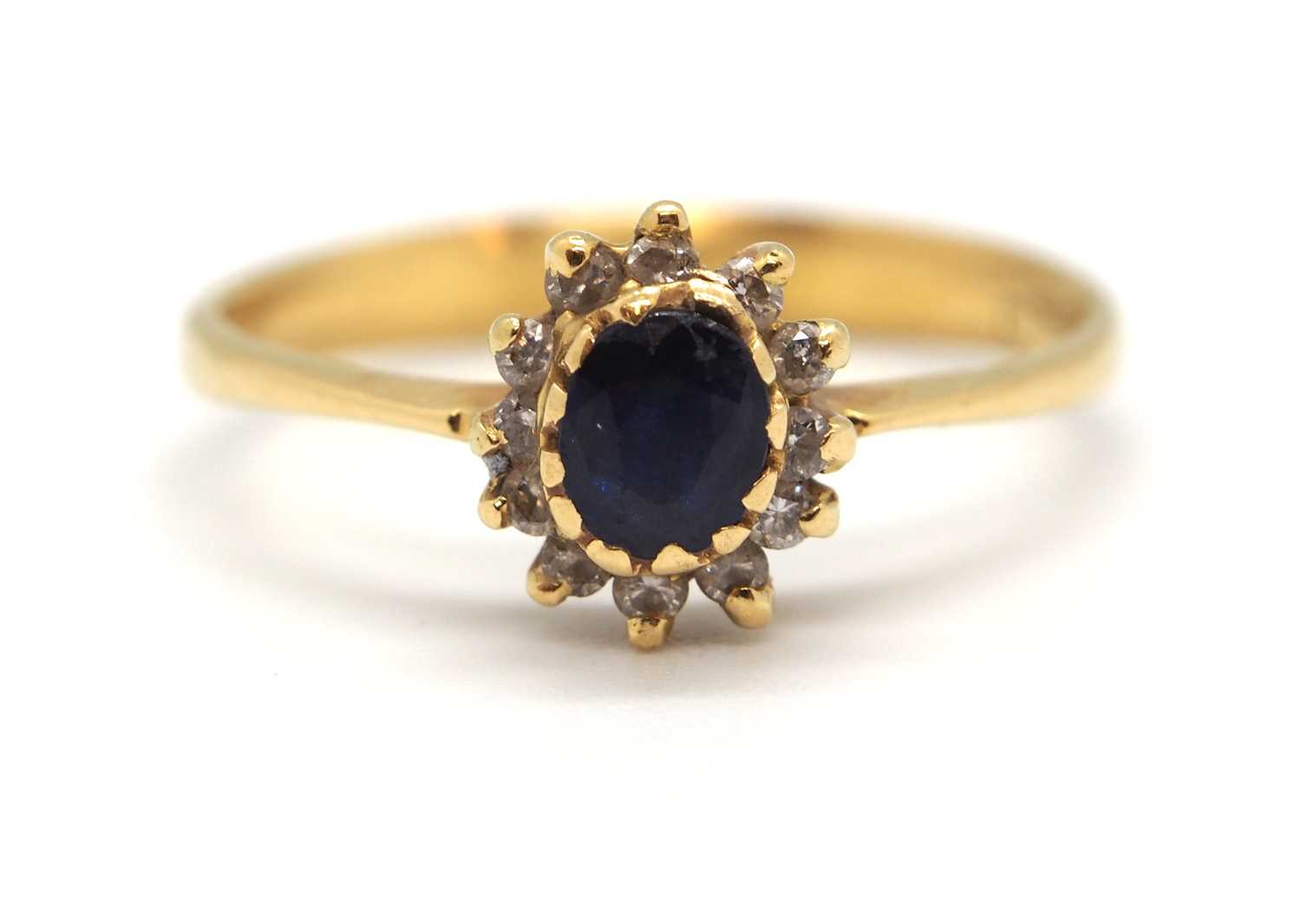 A sapphire and diamond cluster ring, the central oval sapphire surrounded by small round diamonds, - Image 2 of 7
