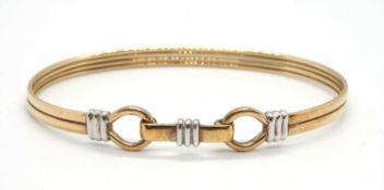 A 9ct bi-colour bangle, the oval bangle with loop terminations and hinged clasp, stamped 375 with