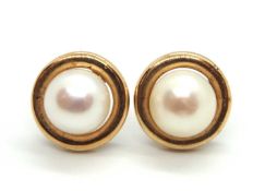 A pair of 9ct cultured pearl earstuds, the round cultured pearls set within a ring of 9ct gold, 11.