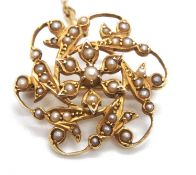 An Edwardian 9ct seed pearl brooch, the openwork brooch with flowerhead motif to centre, set