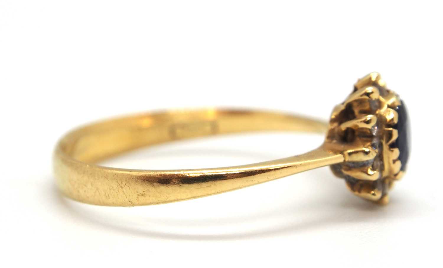 A sapphire and diamond cluster ring, the central oval sapphire surrounded by small round diamonds, - Image 4 of 7