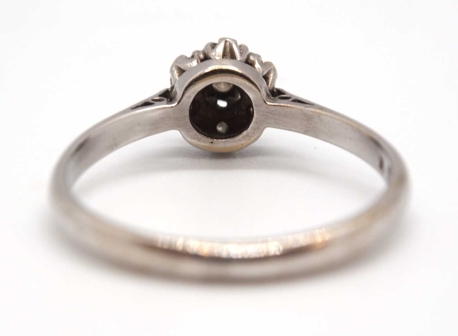 An 18ct white gold cluster ring, comprised of illusion mounted single cut diamonds, with plain - Image 4 of 7