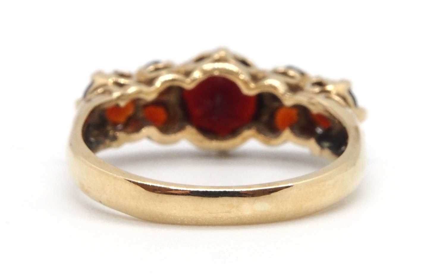 A 9ct garnet ring, the three principal graduated round garnets interspaced with small round garnets, - Image 4 of 7