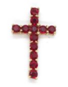 A 9ct cross pendant, set with round red hardstones, stamped 375 to reverse with Birmingham assay