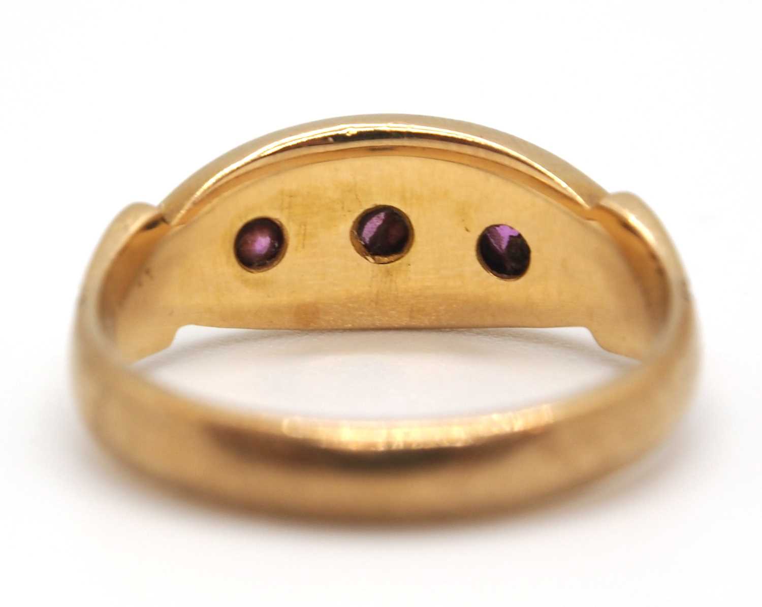 An 9ct ruby ring, the three round gypsy set rubies with plain band stamped 9ct, size I-J, 2.9g - Image 3 of 7