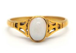 An opal ring, the oval opal cabochon, collet mounted with tapered stylised lotus shape shoulders,