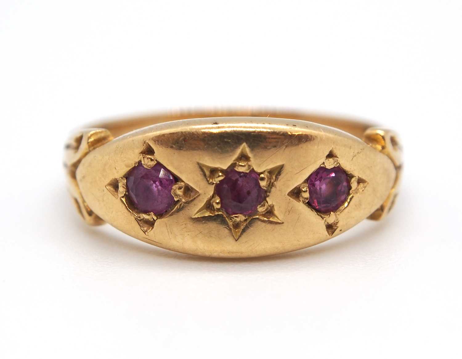 An 9ct ruby ring, the three round gypsy set rubies with plain band stamped 9ct, size I-J, 2.9g - Image 4 of 7