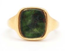 An 18ct bloodstone intaglio signet ring, the bloodstone panel with intaglio of a huntsman and