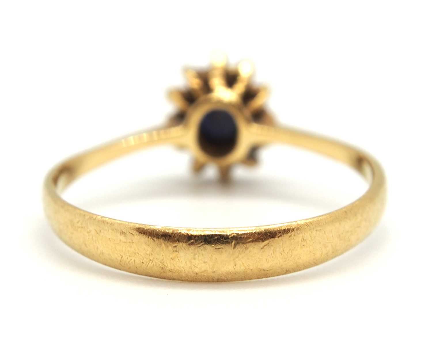 A sapphire and diamond cluster ring, the central oval sapphire surrounded by small round diamonds, - Image 3 of 7