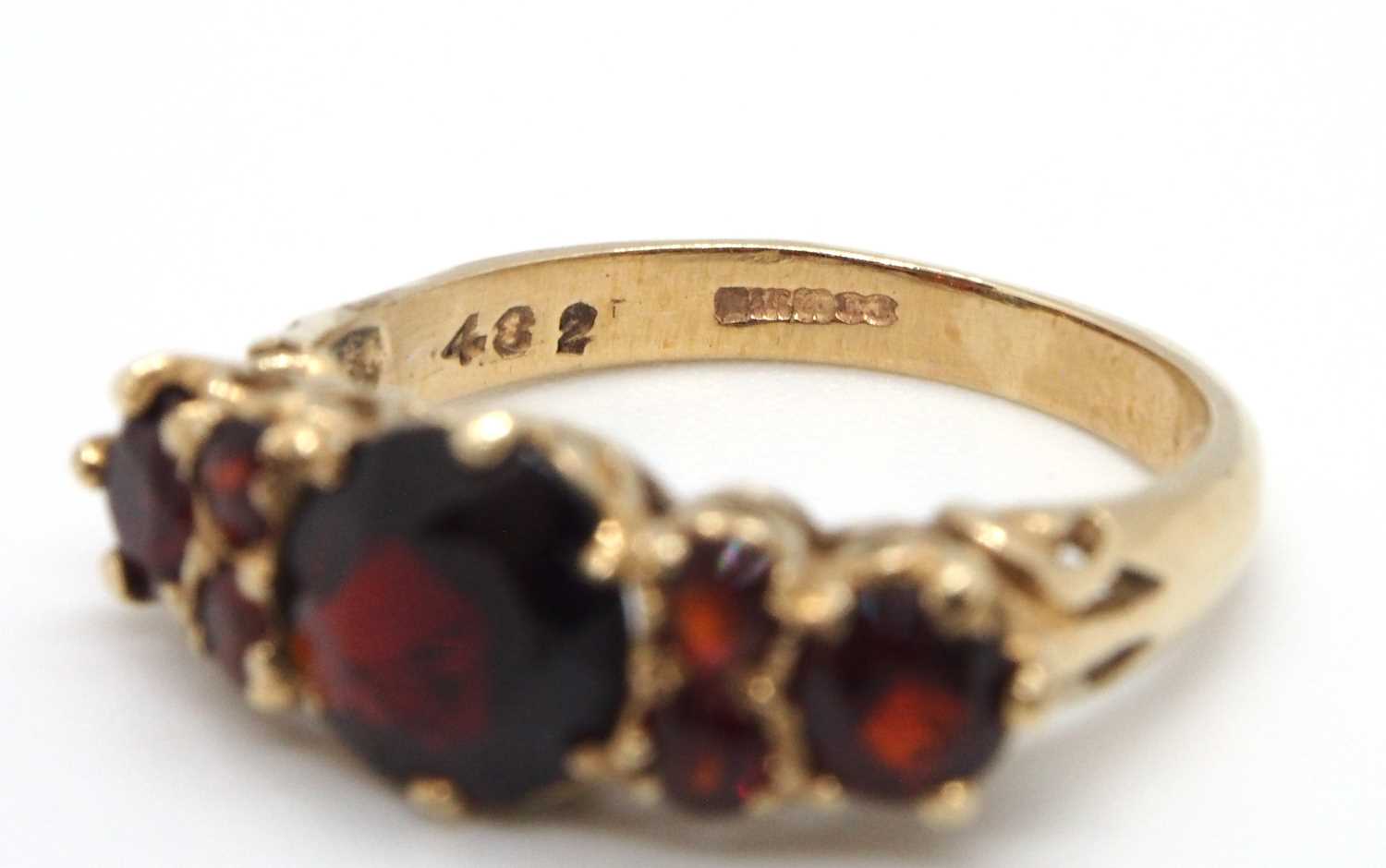 A 9ct garnet ring, the three principal graduated round garnets interspaced with small round garnets, - Image 7 of 7