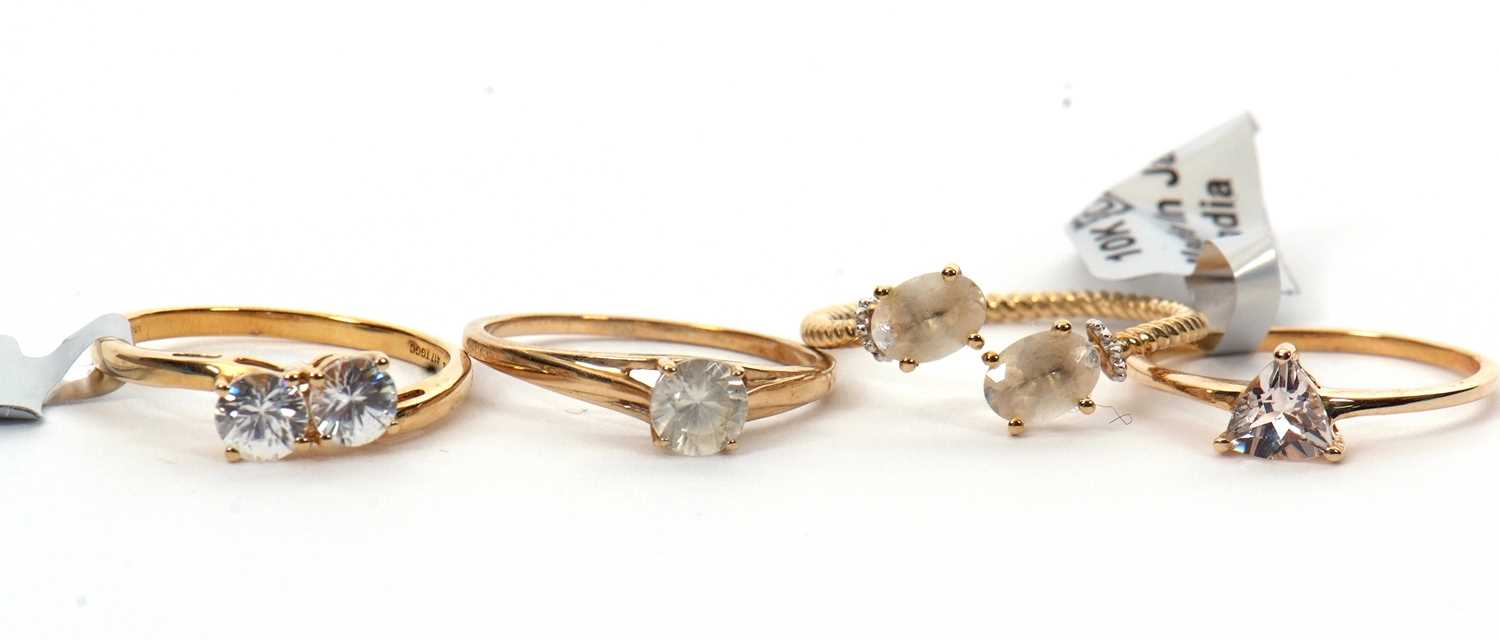 Four gemset rings: to include a 9ct single stone white zircon ring with plain band hallmarked