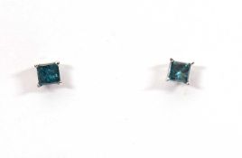 A pair of 14k treated blue diamond earstuds, estimated approx. 0.26cts each (0.52cts total), with