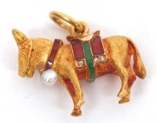 An enamel and diamond donkey pendant, the donkey with enamelled saddle with diamond highlights and a