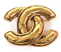 A Chanel brooch, the quilted CC logo in gilt metal and stamped 'Chanel' to reverse, 46mm wide, 21g