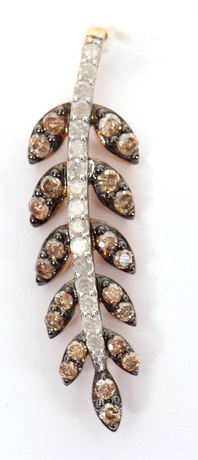 A 9ct brown and white diamond leaf pendant, the stem set with round white diamonds and the leaves
