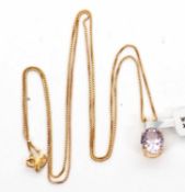 A 10K pink quartz pendant and 9ct chain, the oval pale pink quartz pendant in a four claw mount with
