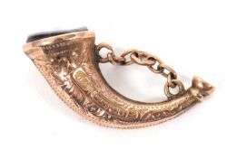 A late Victorian 9ct horn charm, the curved horn with inset agate to one end, hallmarked