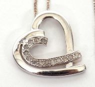 A 9K white gold and diamond heart necklace, the heart pendant set with small round single cut