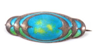 An early 20th century silver and enamel brooch byTheodore Fahrner, the oval brooch in shades of blue