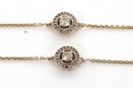 A pair of silver gilt diamond bracelets: both set with a diamond set disc to centre comprised of a