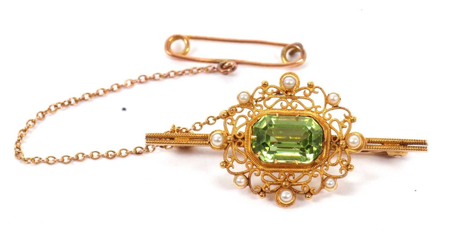 A 15ct peridot and seed pearl brooch, the rectangular mixed cut peridot in a collet and claw