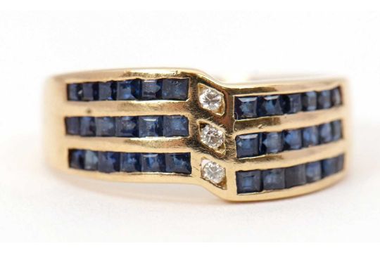 A sapphire and diamond ring, set with three off-set rows of channel set sapphires and three small - Image 2 of 8