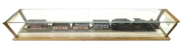A glazed display case containing a 00 gauge locomotive, tender and wagons. Length approximately: