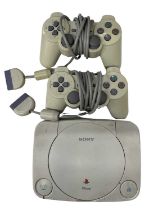 A Playstation One console, with 2 controllers (a/f)