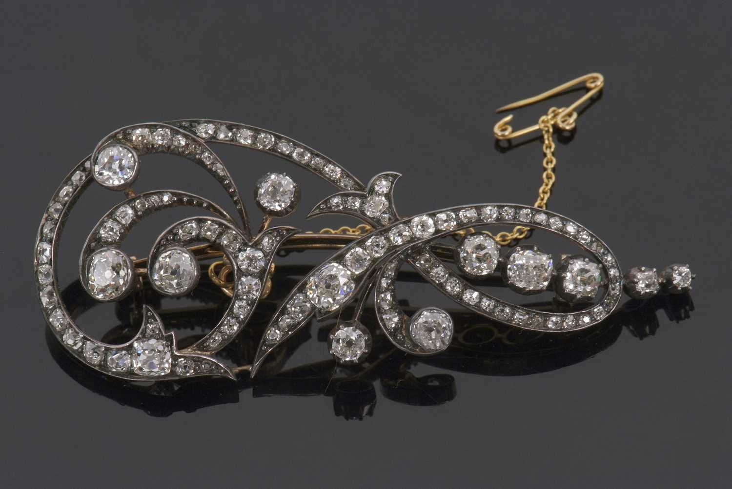 A 19th century diamond brooch, comprised of flourishes set with old mine cut diamonds, total