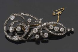 A 19th century diamond brooch, comprised of flourishes set with old mine cut diamonds, total