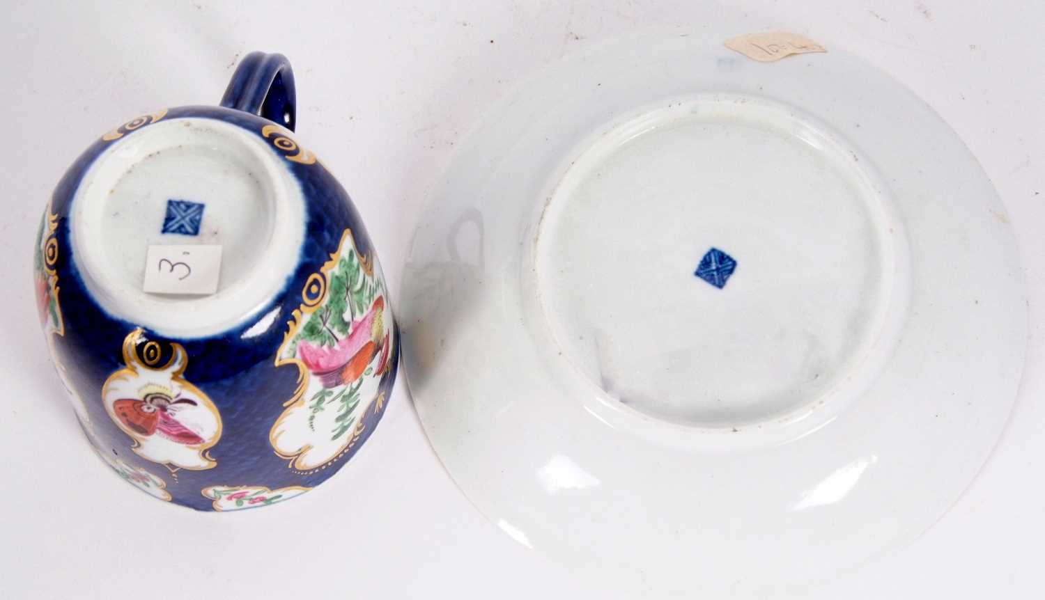An 18th Century Worcester porcelain cup and saucer, the scale blue ground with reserves, painted - Image 3 of 3