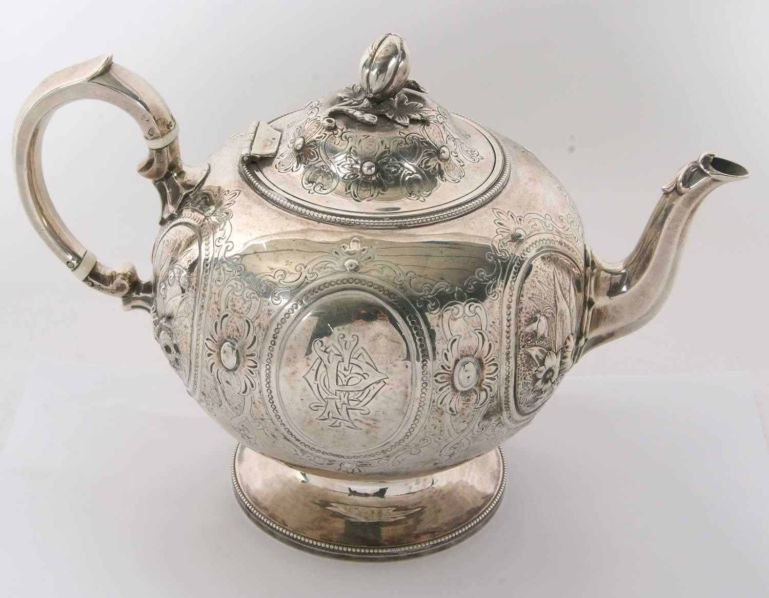 A Victorian silver teapot of globular bullet shaped onto a cast beaded circular spreading foot, - Image 2 of 7