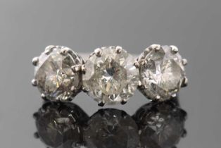 A three stone diamond ring, the three slightly graudated round brilliant cut diamonds, approx. 6.