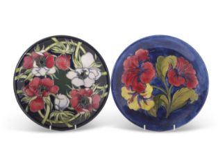 A Moorcroft pottery dish, 1950's, the blue ground with tubelined hibiscus pattern, WM signature to