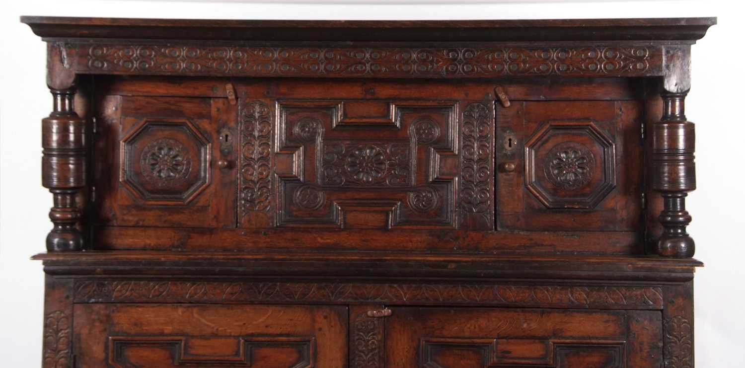A large 17th Century oak court cupboard with moulded cornice over a top section with two panelled - Image 3 of 8