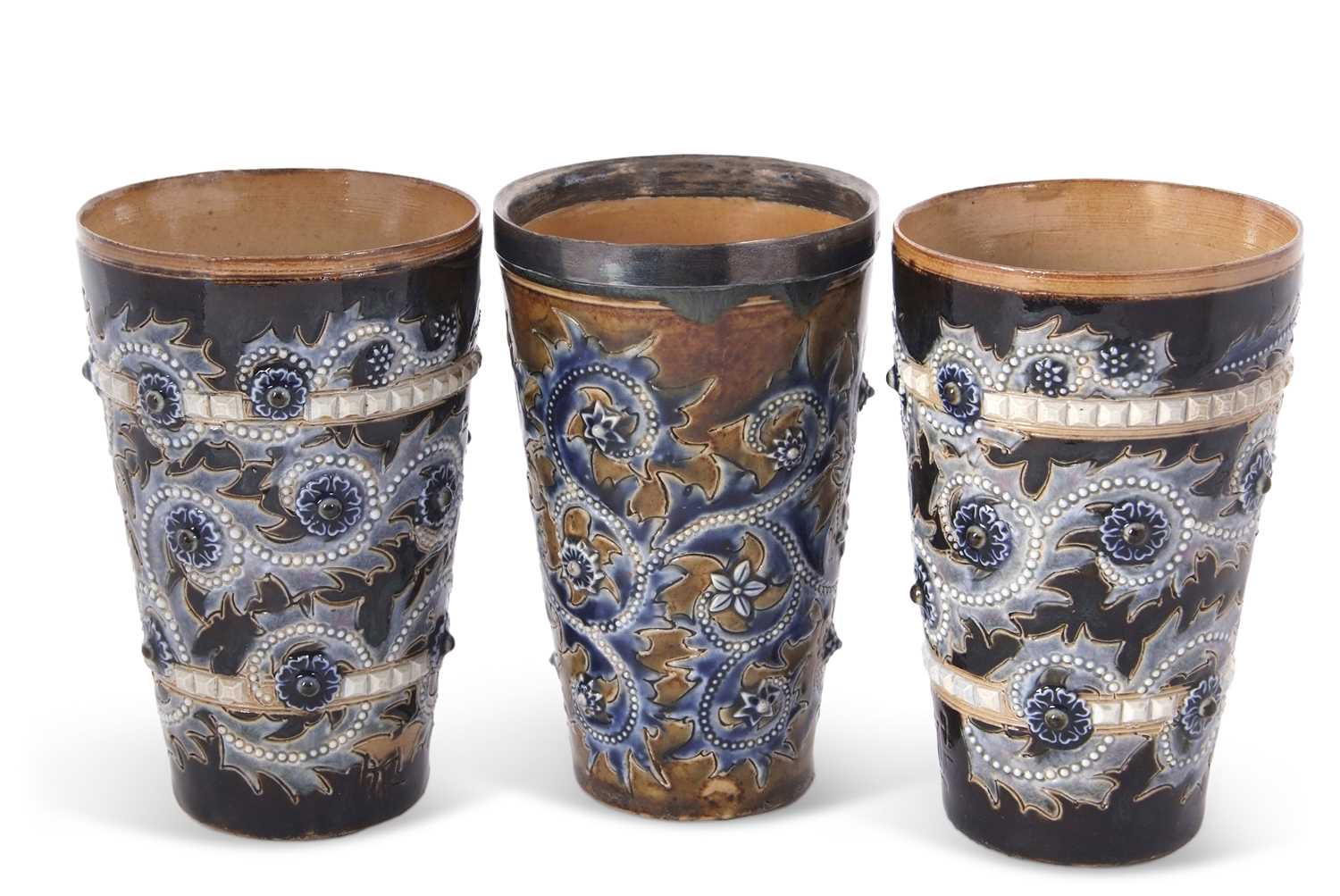 A group of three Doulton Lambeth lemonade beakers all with incised marks for George Tinworth