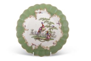 An 18th Century Worcester porcelain plate, the centre painted with exotic birds in a landscape