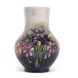 A Mid 20th Century Moorcroft vase of baluster form, the green ground with tubelined decoration of